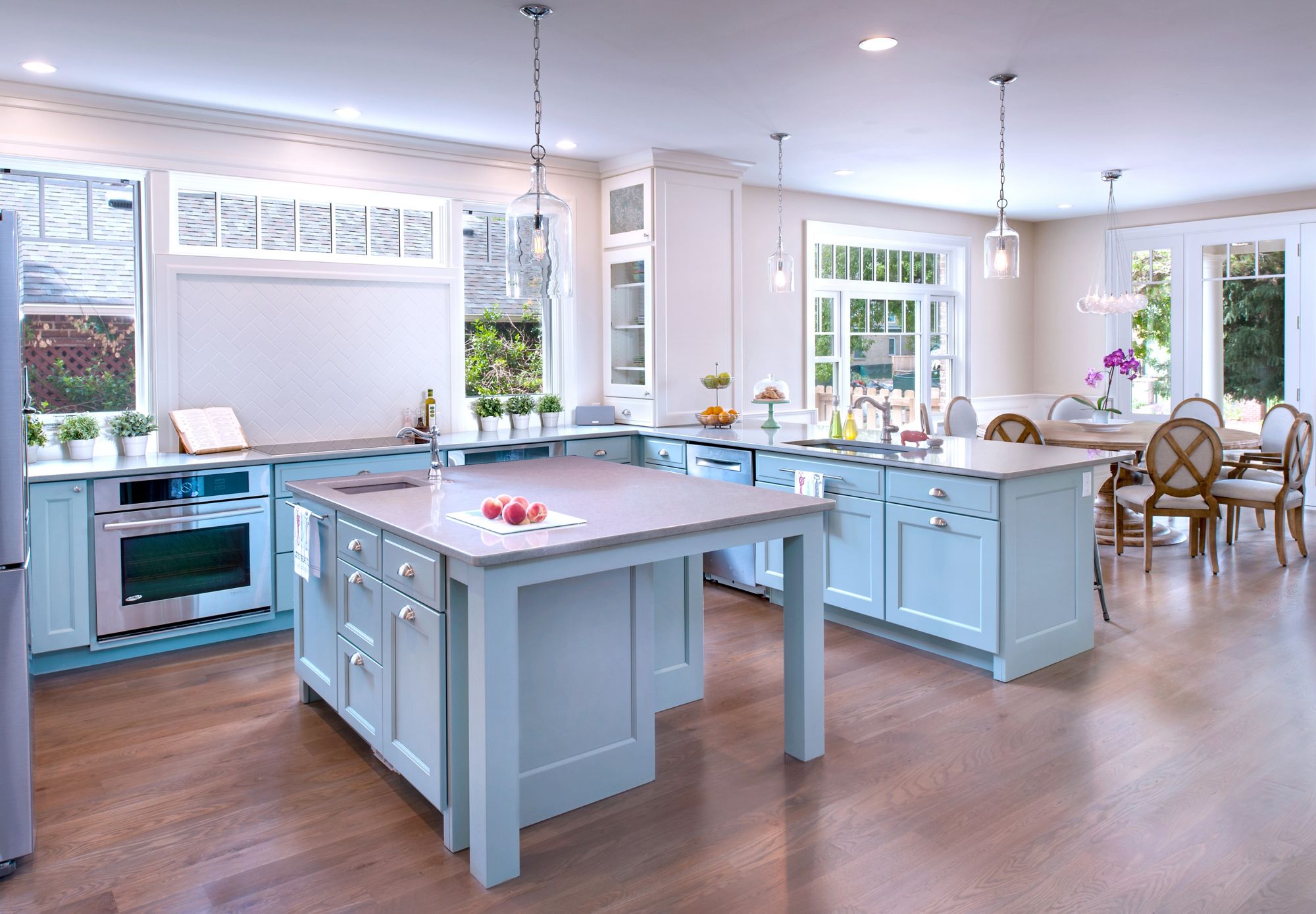 Evoke kitchen with white cabinetry and a blue island